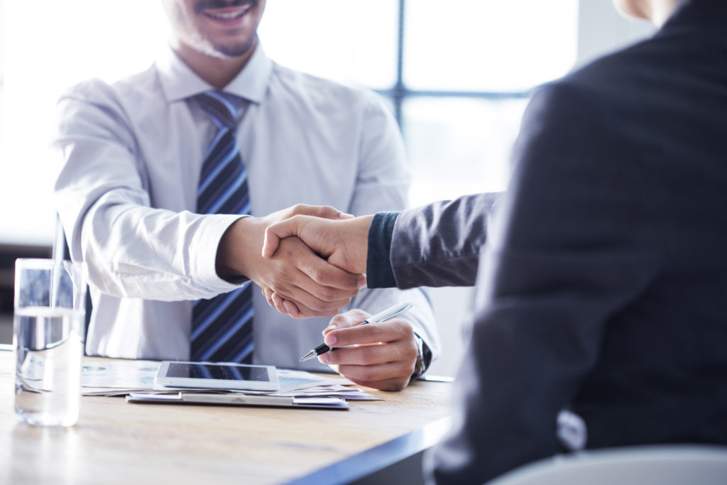 Business handshake in the office Business handshake in the office